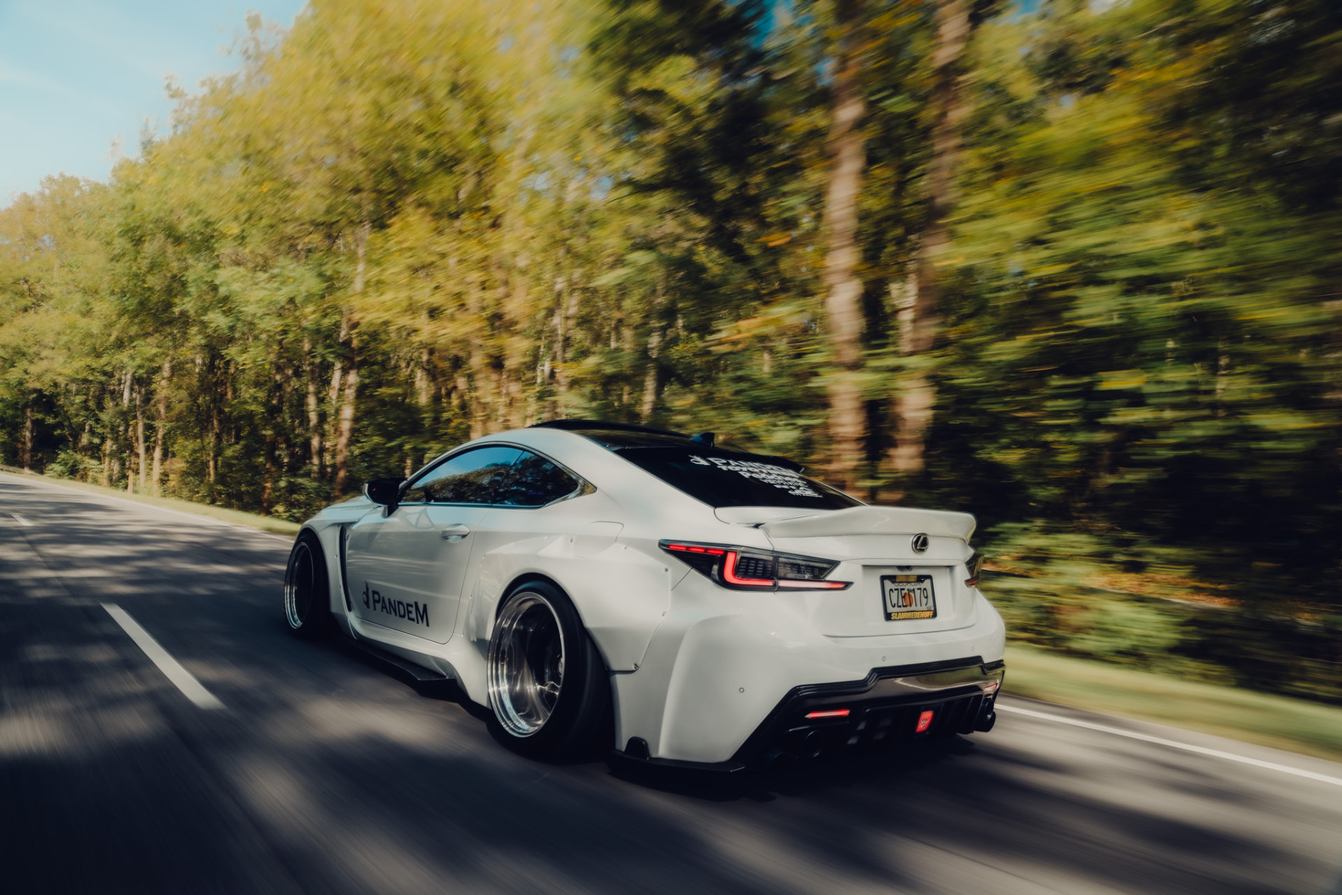 Red Lexus RCF rolling on the highway with motion-blurred background